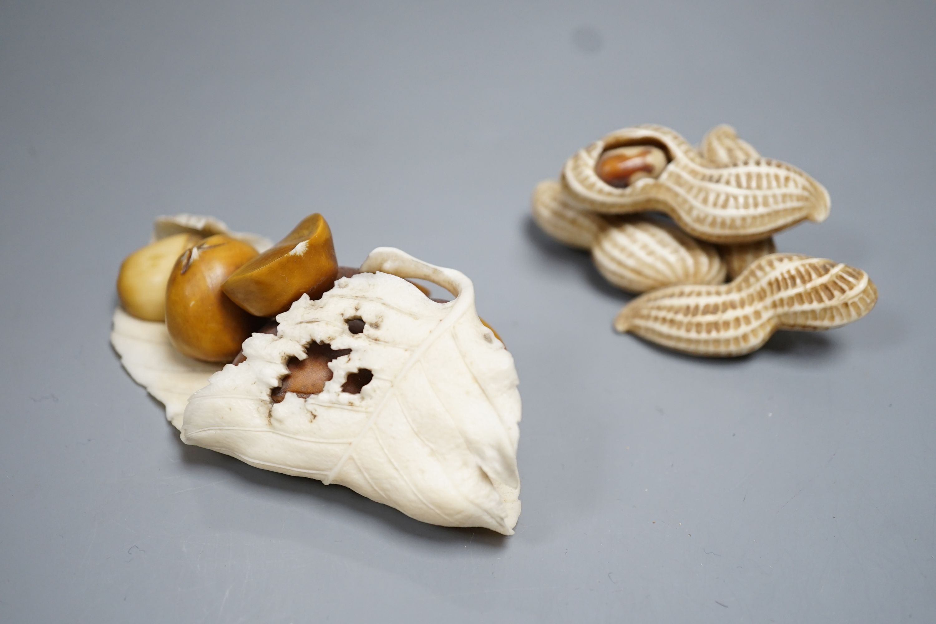 Two Japanese Ivory models of group groups of nuts, first half 20th century, largest 11cm